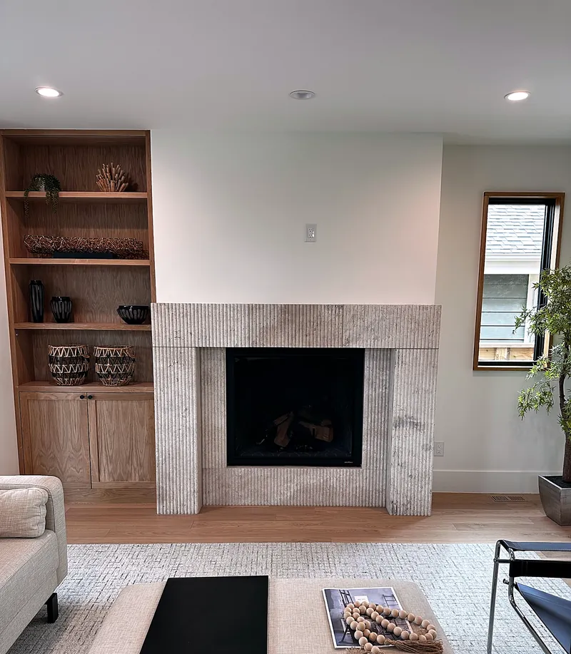 Travertine surround: honed stone with clean mitered edges